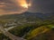 A stunning aerial shot of the majestic mountain ranges with homes along the coastline of California, freeways with cars