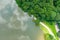 A stunning aerial shot of the still brown waters of the Chattahoochee river surrounded by vast miles of lush green tree