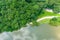 A stunning aerial shot of the still brown waters of the Chattahoochee river surrounded by vast miles of lush green tree
