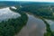 A stunning aerial shot of the still brown waters of the Chattahoochee river surrounded by vast miles of lush green trees