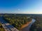 A stunning aerial shot of vast miles of lush green trees, the freeway, the Chattahoochee river and blue sky at sunset