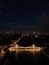 Stunning aerial view of Albert Bridge in London, illuminated by a myriad of vibrant lights