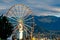 Stunning aerial view of a bright and vibrant ferris wheel situated in a picturesque landscape