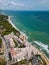 A stunning aerial view of an exclusive residential complex nestled by the sea, boasting luxurious amenities and