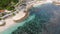 Stunning aerial view of tourists sunbathing on a beautiful beach bathed by a rough sea during, Melasti Beach, Bal