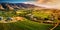 stunning aerial view of a vineyard in full bloom, with neatly aligned rows of grapevines, vibrant green foliage, and a