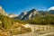 Stunning alpine Landscape at sautumn sunny day. Alpine meadow and road, mountains on background. amazing nature Landscape.