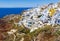 Stunning, amazing and beautiful classic white and caramel color Greek architecture with unbelievable wind mills on Santorini volca
