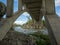 Stunning arched concrete bridge crossing a crystal clear trout stream in Alberta