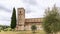 Stunning architectural tandem of Belltower of Abbey Sant Antimo and tall slender cypress.