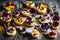 A stunning assortment of sweet baked cream edible flowers and fruit dessert cakes,