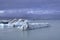 Stunning atmosphere of huge iceberg reflecting in the cool glacial water near the glacier. Glacial Lake jokulsarlon