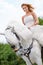 Stunning atop her steed - Wedding Day. A gorgeous bride posing for wedding photos atop her white horse.