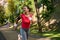 Stunning attractive middle aged fit woman, sportswoman, athlete, runner, jogger running on the city park. Fitness, cardio workout