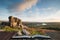 Stunning Autumn sunset landscape image of view from Leather Tor towards Burrator Reservoir in Dartmoor National Park coming out of