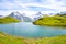 Stunning Bachalpsee lake in the Swiss Alps photographed with famous mountain peaks Eiger, Jungfrau, and Monch. Alpine lake and