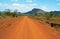 Stunning background landscape driving red dusty dirt roads of Africa