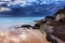 Stunning beach and coastal rocks before sunrise