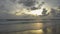 Stunning beach with dramatic sky during sunset in phuket. The waves splashing on the sandy beach in the evening.