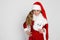 Stunning beautiful little girl with long blond, dressed in a red cap Santa Claus and elegant clothes