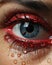 Stunning blue eye with red glitter makeup and water droplets on the skin. Generative AI