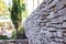 Stunning brick wall of Jerusalem stones in the beautiful garden near Herzl`s cemetery. Jerusalem, Israel.