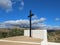 Stunning Christian cross silhouette stands against the backdrop of a vibrant blue sky in Spain