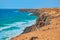Stunning cliff with rocks and sand overlooking the ocean in Fuerteventura