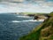 Stunning coastline of Ireland in Kilkee area. Low cloudy sky, warm sunny day. Travel, tourism and sightseeing concept. Irish