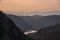 Stunning colorful landscape image of view down Honister Pass to Buttermere from Dale Head in Lake District during Autumn sunset