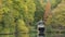 Stunning colorful vibrant Autumn Fall landscape image of boathouse on lake in forest scene