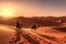 A stunning desert landscape image featuring the golden dunes of the nearby Sahara Desert, with a camel caravan in the distance,