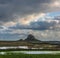 Stunning dramatic landscape image of Lindisfarne, Holy Island in Northumberland England during Winter