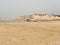 Stunning Egyptian beachscape with large rocks jutting out of the ocean on a backdrop of sandy beach