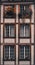 Stunning exterior view of a white and brown building with windows with potted plants in Switzerland