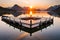 A stunning, fiery sunset over a calm, reflective lake surrounded by mountains