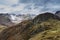 Stunning flying drone landscape image of Langdale pikes and valley in Winter with dramatic low level clouds and mist swirling
