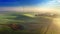 Stunning foggy sunrise on field with wind turbine in autumn