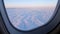 Stunning footage of aerial view above clouds from airplane window.