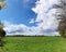 Stunning high resolution panorama of a northern german agricultural landscape on a sunny day with white cloud formations on a blue