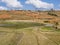 Stunning hilltop bara village with colorful cultivated fields in the valley, Antsirabe, Madaga