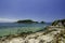 Stunning image rocky beach surrounded by clear blue sea water at Kapas Island, Malaysia.