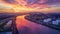 Stunning Industrial Sunset over River with City Skyline. Vibrant Colors Reflecting on Water. Scenic Urban Landscape. AI