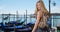 Stunning inviting white woman beckons to the camera in Venice, Italy