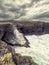 Stunning Irish seascape with rough stone coast line and powerful Atlantic ocean. Kilkee area, Ireland. Dramatic sky. Detailed