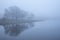 Stunning landscape image of misty Derwentwater in Lake District on cold Winter morning