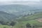 Stunning landscape image of the view from Higger Tor in the Peak District National Park in Egnland with light fog across the