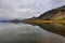 Stunning landscape at Lake Thveit in Iceland. wonder of nature with the sky and the mountain reflected in a mirror of water. Beaut