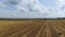 Stunning landscape, massive field with many round hay bales lying all over it