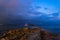 Stunning landscape with storm and lightning dawn with rocky coastline and long exposure Mediterranean Sea